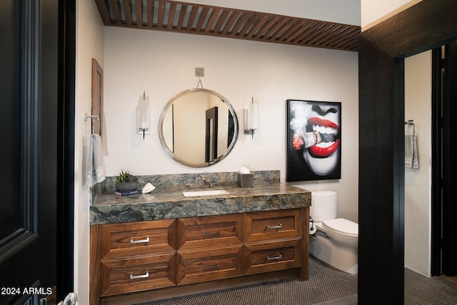 bathroom with toilet and vanity