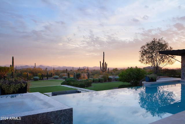 view of pool at dusk