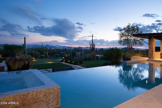 view of pool at dusk