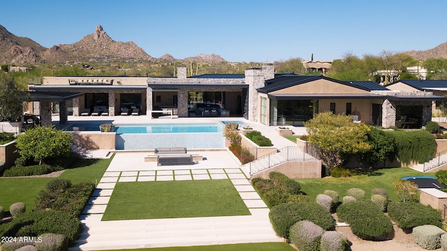 view of swimming pool featuring a patio area and a mountain view