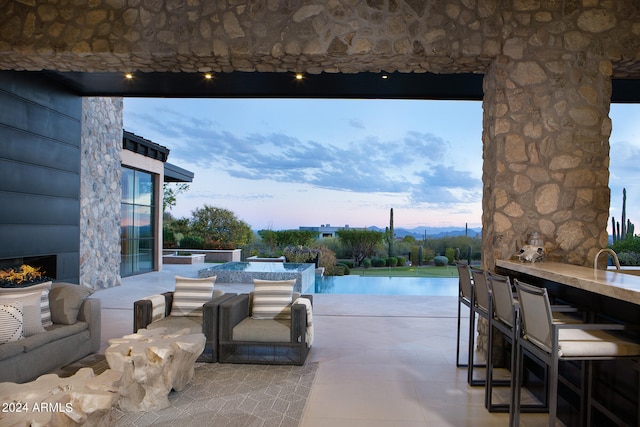 view of patio terrace at dusk