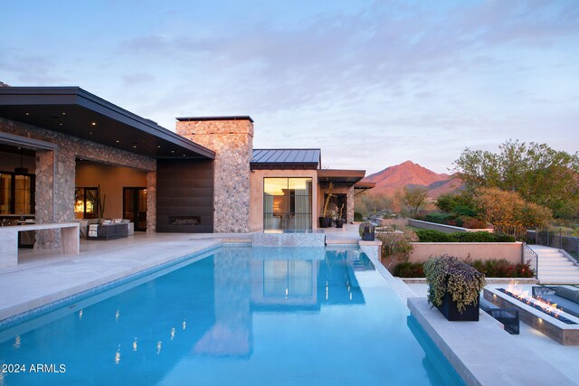 view of pool featuring a patio area and a mountain view