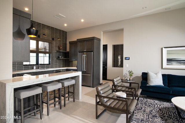 living room featuring sink and light tile floors