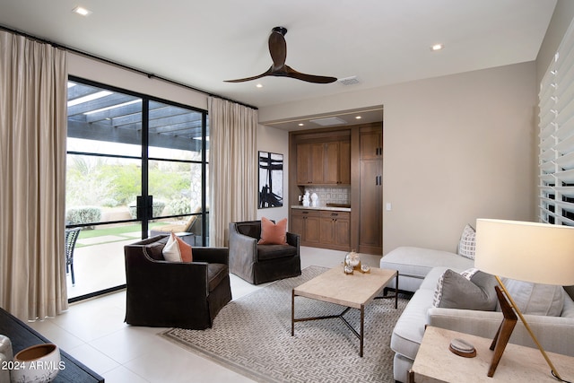 tiled living room with ceiling fan