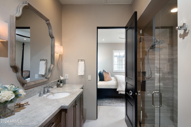 bathroom featuring oversized vanity, an enclosed shower, and tile flooring