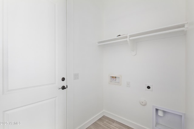 washroom featuring hookup for a washing machine, hookup for a gas dryer, light wood-style floors, hookup for an electric dryer, and laundry area