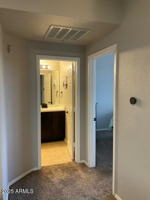 5345 E Van Buren St Unit 370, Phoenix, AZ 85008 - corridor featuring light carpet and baseboards