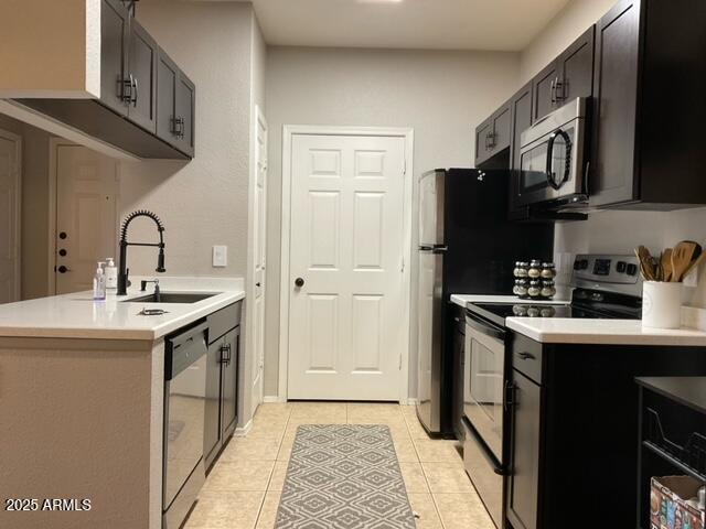 5345 E Van Buren St Unit 370, Phoenix, AZ 85008 - kitchen featuring appliances with stainless steel finishes, a sink, light tile patterned flooring, and light countertops