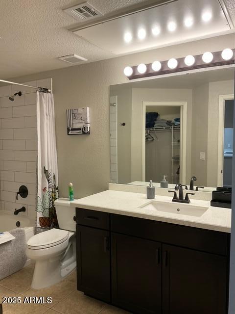 5345 E Van Buren St Unit 370, Phoenix, AZ 85008 - bathroom with vanity, toilet, a textured ceiling, tile patterned flooring, and shower / bath combo with shower curtain