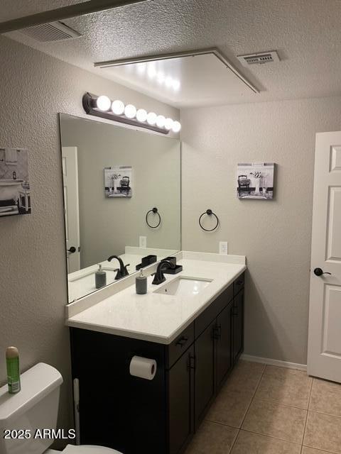 5345 E Van Buren St Unit 370, Phoenix, AZ 85008 - bathroom with tile patterned flooring, toilet, vanity, and a textured ceiling
