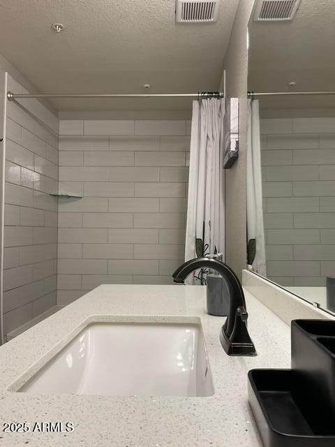 5345 E Van Buren St Unit 370, Phoenix, AZ 85008 - detailed view of a sink, a textured ceiling, and fire sprinkler in ceiling