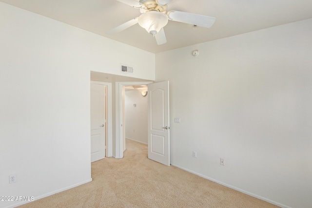 carpeted empty room featuring ceiling fan