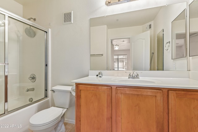 full bathroom with tile patterned flooring, ceiling fan, toilet, shower / bath combination with glass door, and vanity