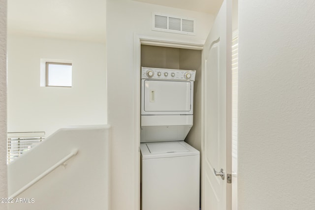 laundry area with stacked washer / drying machine