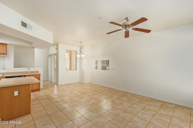 kitchen featuring ceiling fan with notable chandelier, pendant lighting, kitchen peninsula, and light tile patterned floors