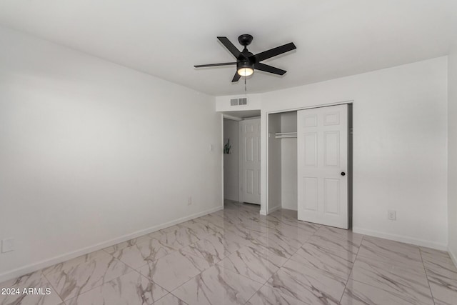 unfurnished bedroom with ceiling fan and a closet