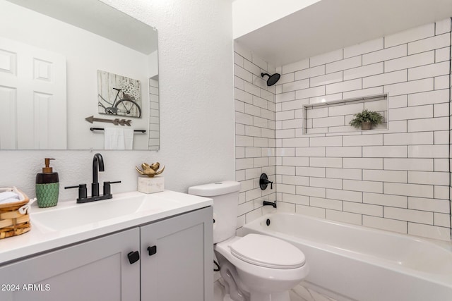 full bathroom with vanity, tiled shower / bath combo, and toilet