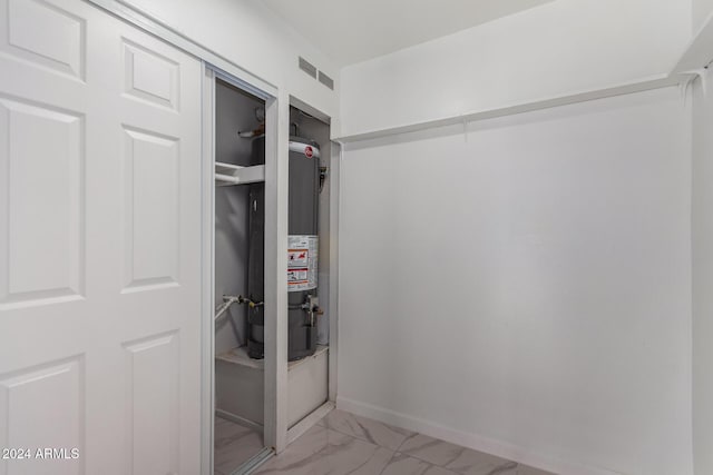 utility room featuring water heater