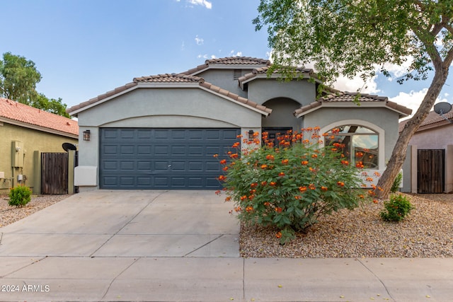 mediterranean / spanish-style home featuring a garage