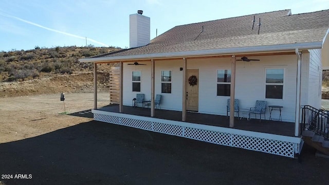 back of house with ceiling fan and covered porch