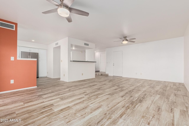 unfurnished living room with visible vents, ceiling fan, and light wood-style flooring