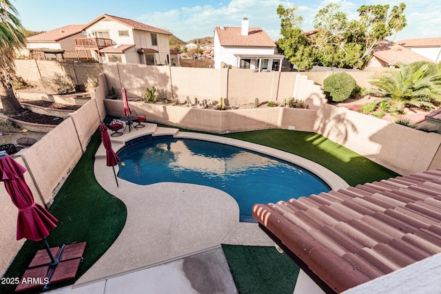 view of pool featuring a fenced backyard, a residential view, and a fenced in pool