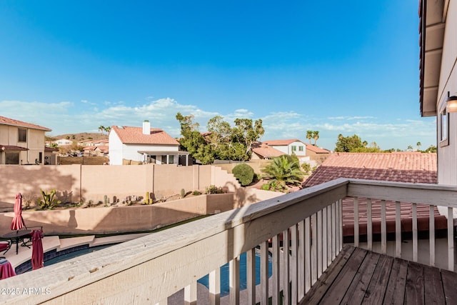 wooden deck featuring a residential view and fence