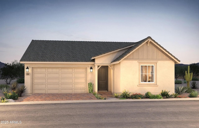 16448 W Whispering Wind Dr, Surprise, AZ 85387 - view of front of house featuring a garage, stucco siding, and driveway