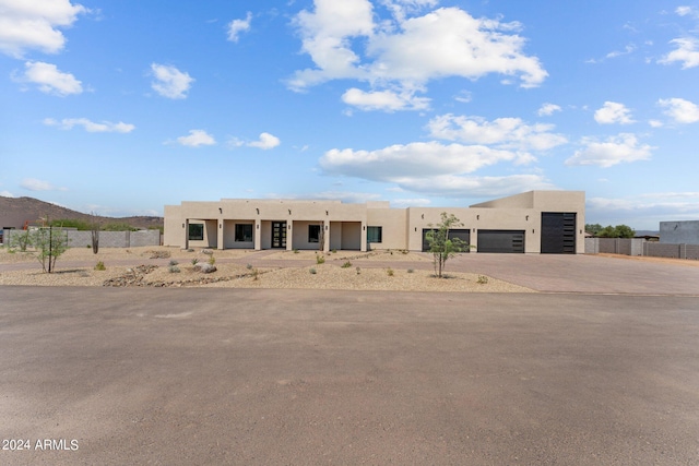 pueblo-style house featuring a garage