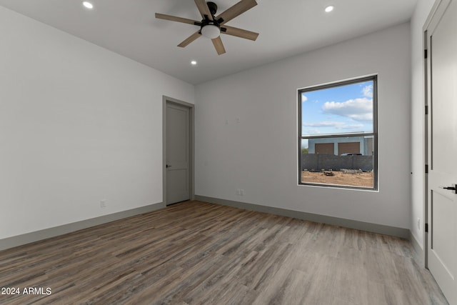 unfurnished room with light wood-type flooring and ceiling fan