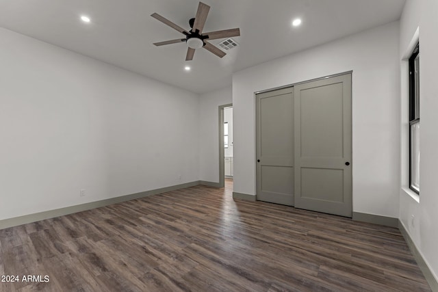 unfurnished bedroom featuring ceiling fan, hardwood / wood-style floors, and a closet