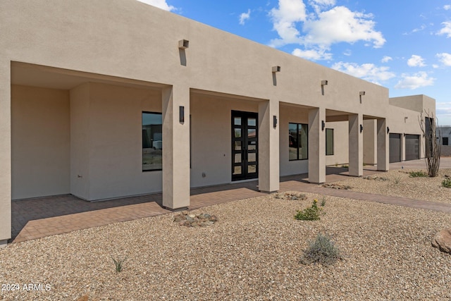 back of property featuring a patio and french doors