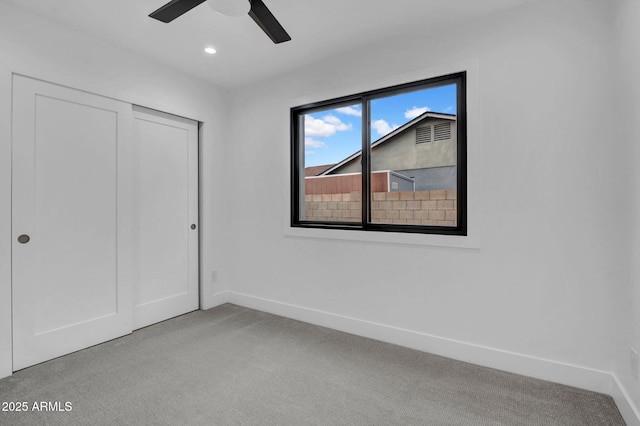 unfurnished bedroom featuring light carpet, baseboards, a closet, recessed lighting, and ceiling fan