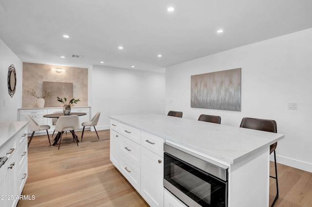 office area with recessed lighting, baseboards, and light wood-style flooring