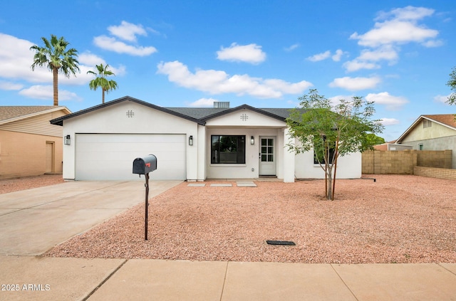 ranch-style home featuring driveway, fence, an attached garage, and stucco siding