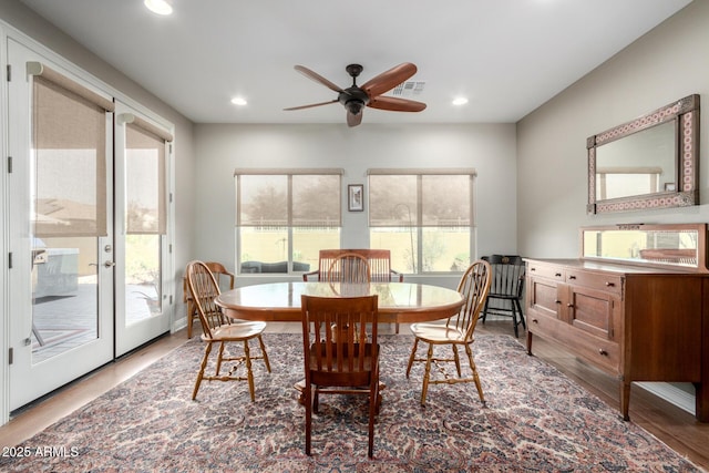 dining room featuring ceiling fan, hardwood / wood-style floors, and french doors