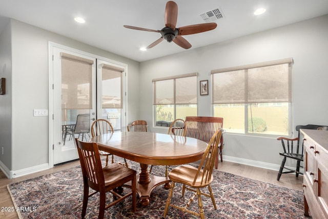 dining room with ceiling fan and light hardwood / wood-style flooring