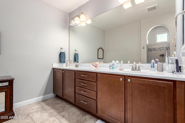 bathroom with vanity, a shower, and tile patterned flooring