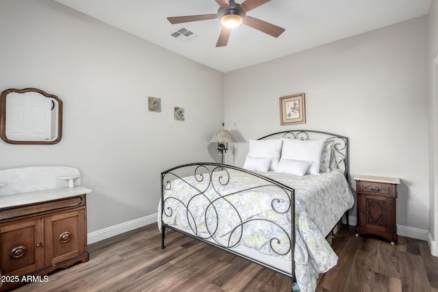 bedroom with ceiling fan and dark hardwood / wood-style flooring