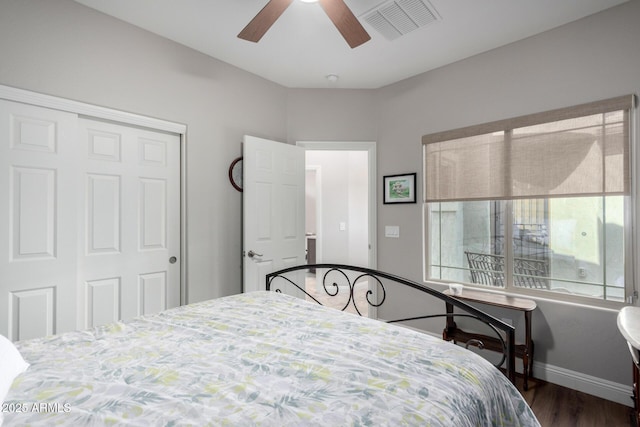 bedroom with ceiling fan, a closet, and dark hardwood / wood-style flooring