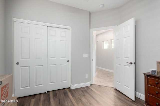 bedroom featuring a closet and dark hardwood / wood-style flooring