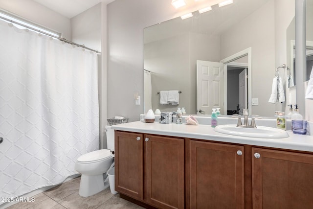 bathroom with vanity, toilet, and tile patterned floors