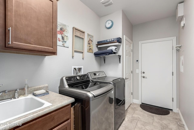 laundry room featuring cabinets, sink, independent washer and dryer, and light tile patterned flooring