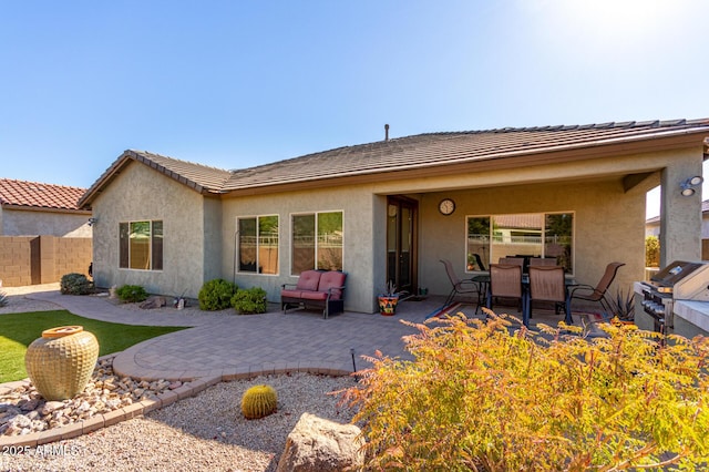 back of property with a patio