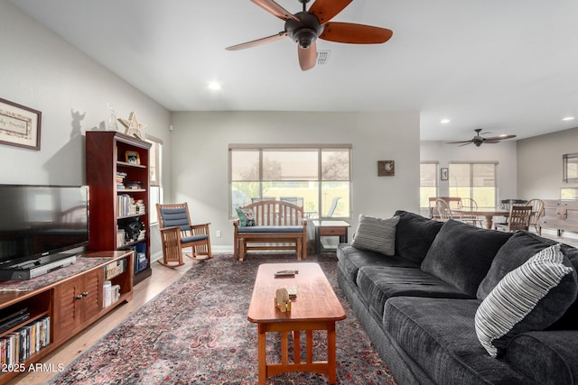 living room with light hardwood / wood-style flooring and ceiling fan