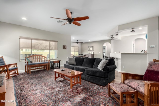 living room with hardwood / wood-style flooring and ceiling fan