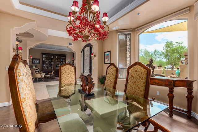 dining space featuring tile patterned floors, a raised ceiling, and a chandelier