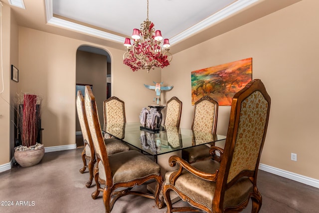 dining room featuring crown molding, baseboards, arched walkways, a notable chandelier, and a raised ceiling