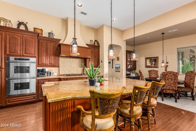 kitchen with visible vents, light stone countertops, and appliances with stainless steel finishes