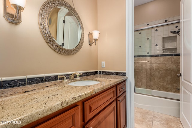 bathroom with tile patterned floors, tiled shower / bath combo, and vanity